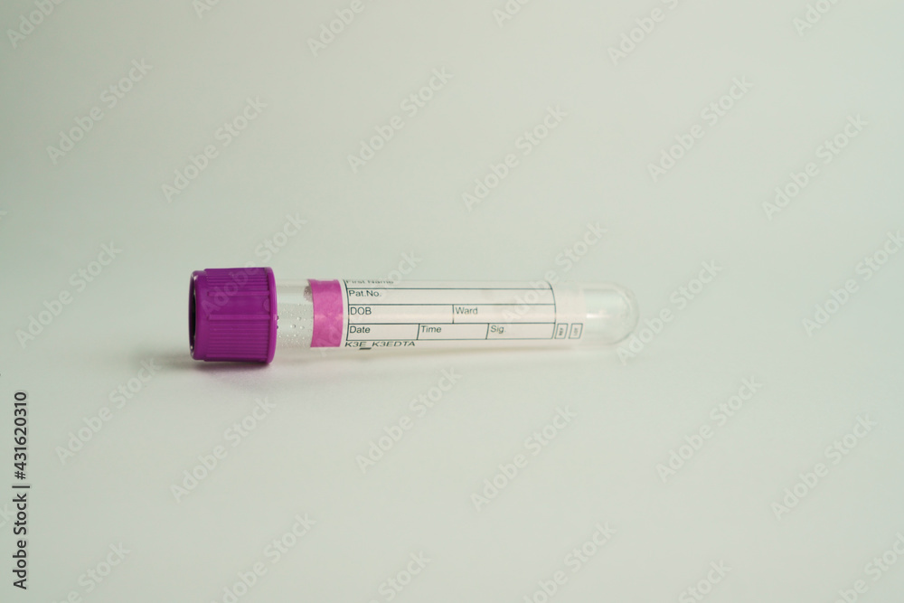 Obraz premium vacuum tube for collection and blood samples on white background..Transparent with purple lid. Label to identify the data. Selective focus. lid. Label to identify the data. Selective focus.
