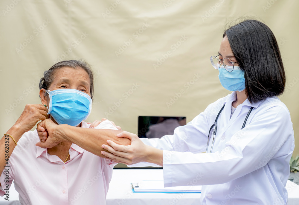 A professional doctor physical therapy is doing hand therapy to elderly patients in the hospital