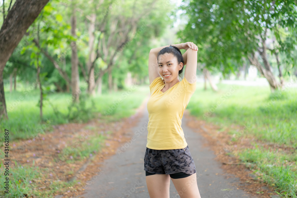 Asian women are stretching before exercising in the park. Asian women are stretching before exercising in the park.