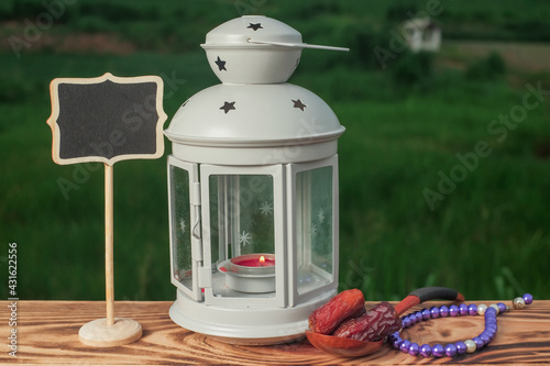 Dates fruits   beads and lantern  on old wooden table. Ramadan Concept