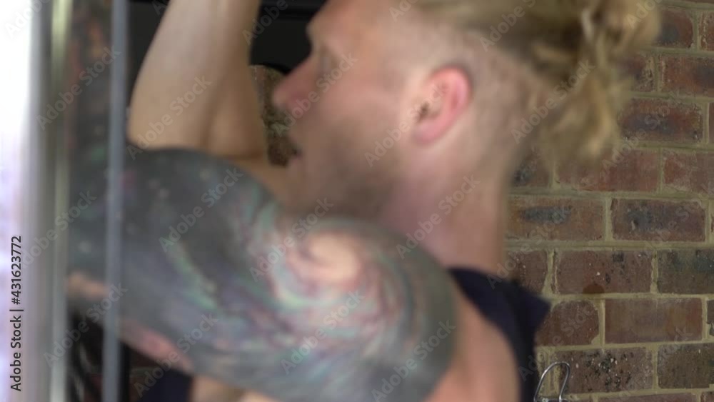 Muscly man in home gym exercising close up man doing chin ups Muscly man in home gym exercising close up man doing chin ups