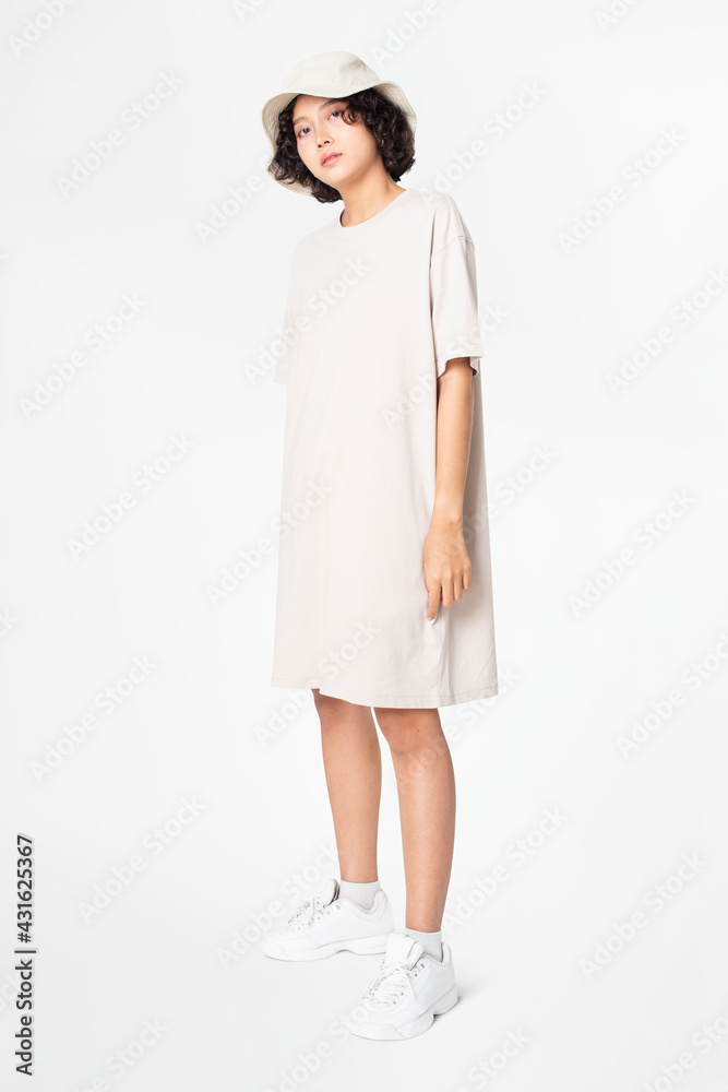 Woman in white t-shirt dress and bucket hat casual wear apparel Woman in white t-shirt dress and bucket hat casual wear apparel