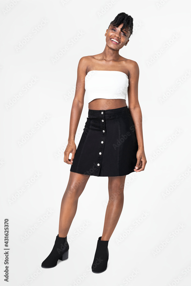 Woman in white bandeau top and black a-line skirt casual fashion full body Woman in white bandeau top and black a-line skirt casual fashion full body