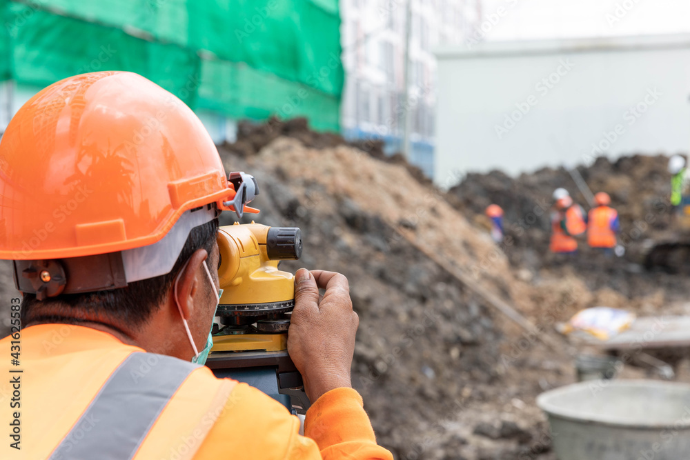 Surveyors are working with construction workers. Surveyors are working with construction workers.