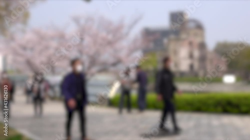 Wallpaper Mural Blurred shot of tourists with mask walking in Hiroshima Peace Memorial Park, Japan. 4K. People traveling in Hiroshima. Torontodigital.ca