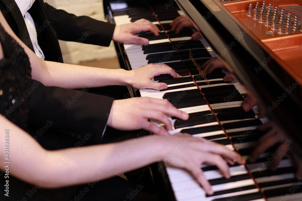 Fototapeta premium playing the piano, couple piano duet