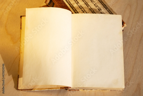 Old vintage book on wooden table. Open book with blank pages