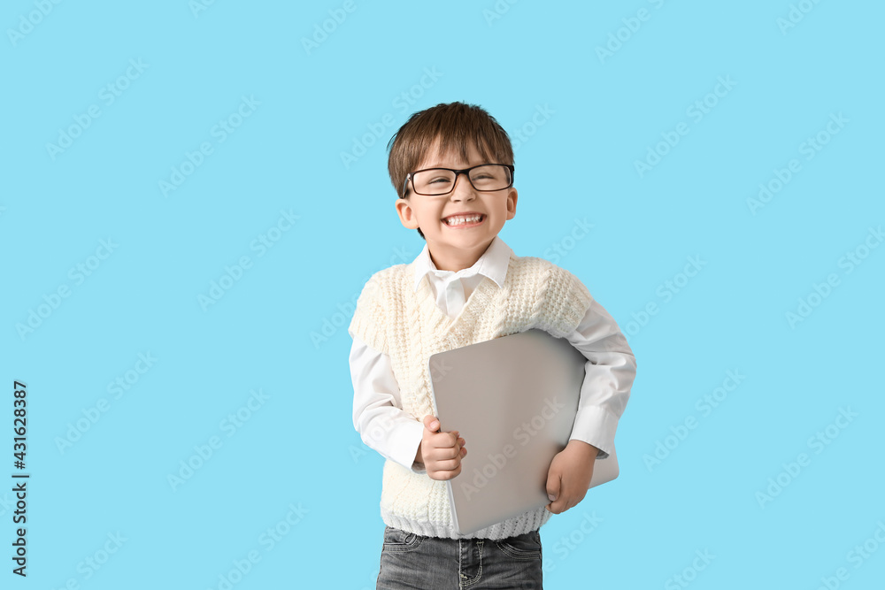 Cute little businessman with laptop on color background Cute little businessman with laptop on color background