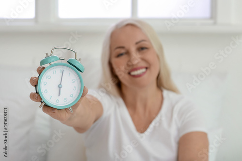 Mature woman with alarm clo...