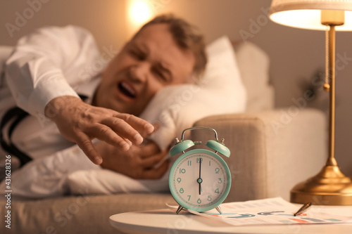 Mature man turning off alar...