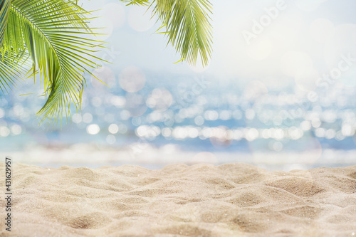 Abstract seascape with palm tree, tropical beach background. blur bokeh light of calm sea and sky. summertime vacation background concept. © jakkapan
