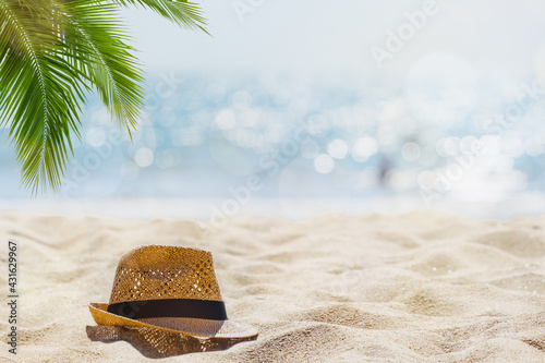 Abstract seascape with palm tree, tropical beach background. blur bokeh light of calm sea and sky. summertime vacation background concept.