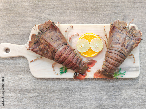 Fresh Sand Lobster or Flathead Lobster or Slipper Lobster decorated with herbs and vegetables .Selective focus.