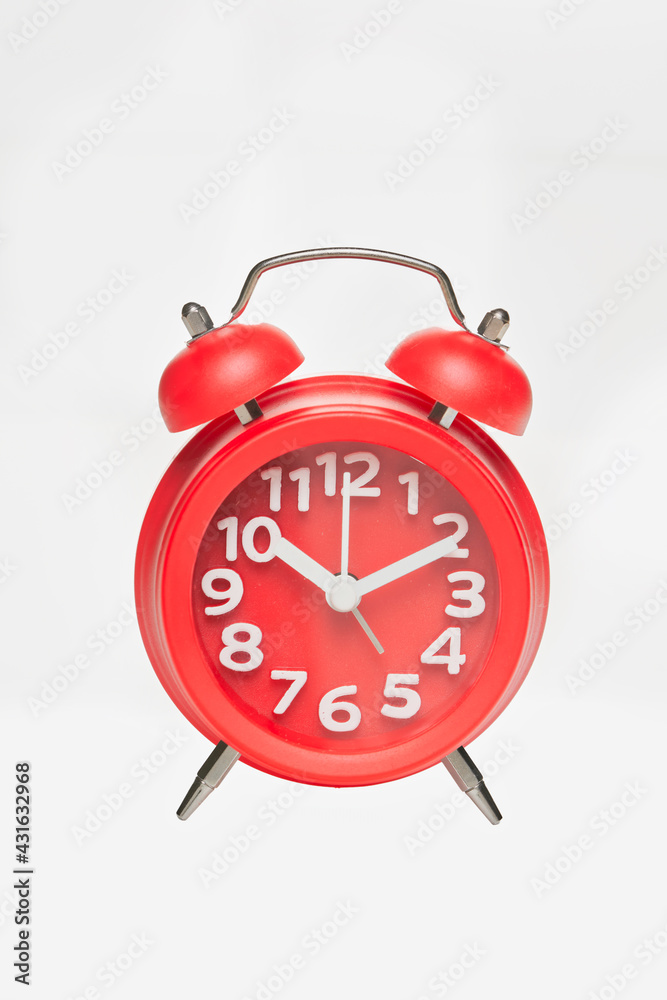Red retro alarm clock with digital dial and hour hands on white background Red retro alarm clock with digital dial and hour hands on white background