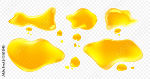 Spills of yellow juice, oil or honey isolated on transparent background. Vector realistic set of clear liquid puddles and drops of orange, lemon or mango juice top view