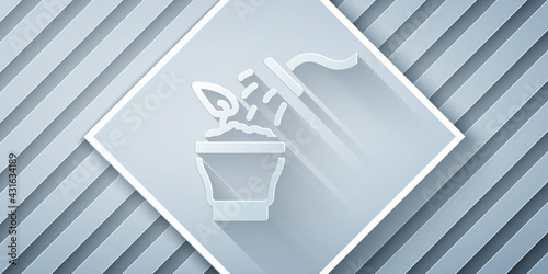 Paper cut Spraying a house plant with a spray gun icon isolated on grey background. Moistening of foliage. Care for home flowers. Paper art style. Vector