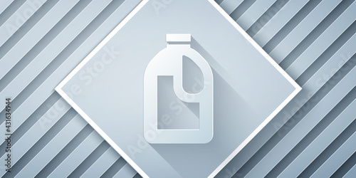Paper cut Plastic bottle for laundry detergent, bleach, dishwashing liquid or another cleaning agent icon isolated on grey background. Paper art style. Vector