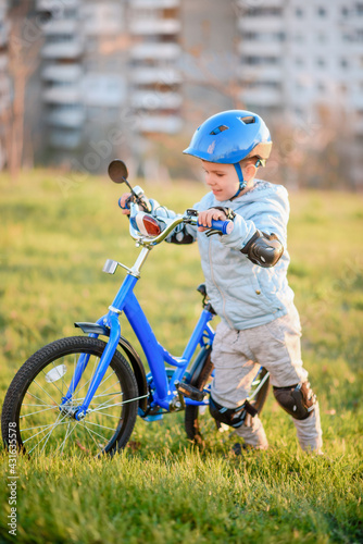 Cute child is driving a bike on a sunny day at sunset © johnalexandr