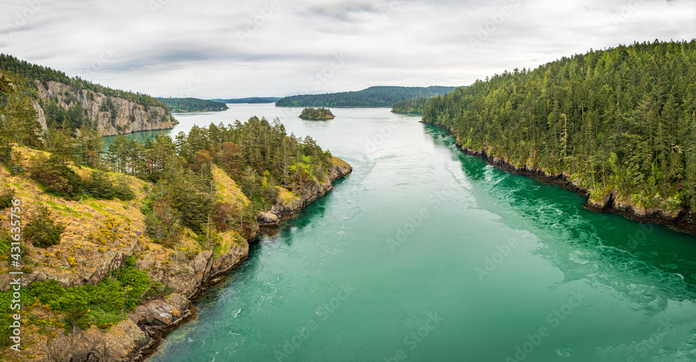 A look across at Skagit Bay and Deception Pass with overcast skies and turquoise water