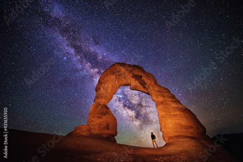 Portrait under delicate arch with the milky way, Arches National Park photo
