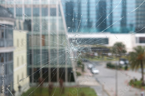 Broken glass, glass cracked from an accident with blurred architecture background