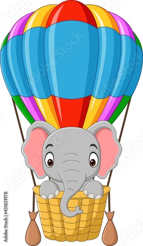 Cartoon baby elephant riding a hot air balloon
