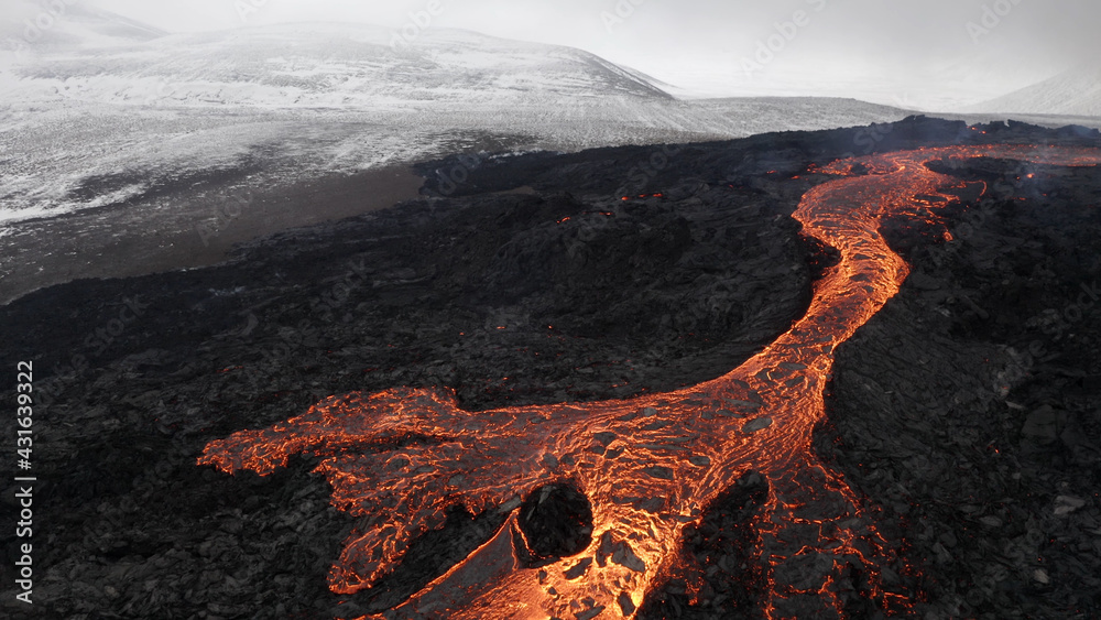 lava eruption volcano with snowy mountains, Aerial view
Hot lava and magma coming out of the crater, April 2021 
