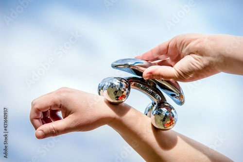 Cuadro en lienzo A girl does a hand massage with a roller massager