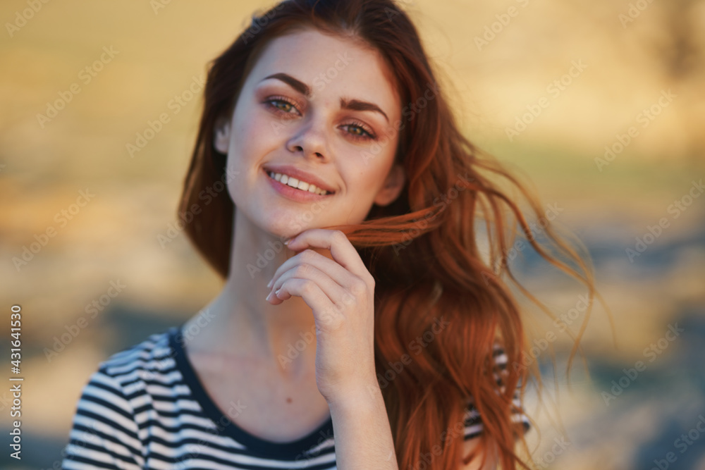 happy red-haired woman outdoors in the mountains smile model hairstyle happy red-haired woman outdoors in the mountains smile model hairstyle