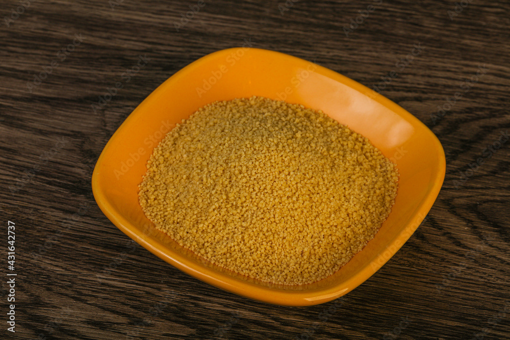 Raw cous cous heap in the bowl Raw cous cous heap in the bowl