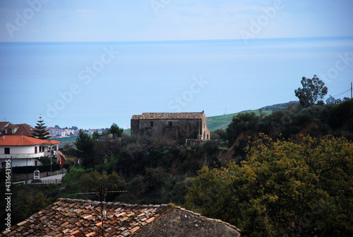 Old house and the sea on the background. photo