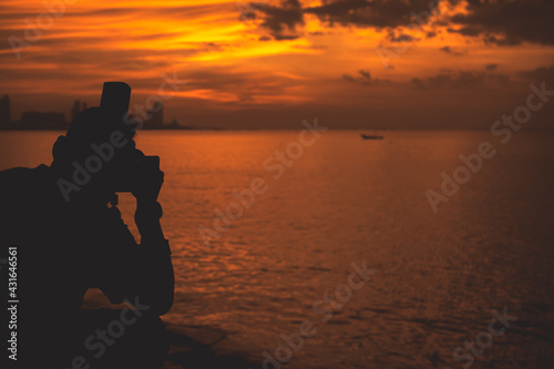 Silhouette photographer with nature sunset
