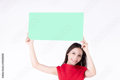 Young asian female showing blank sign card cheerful and happy smiling - copy space for text. Beautiful smiling young woman model isolated on white background.