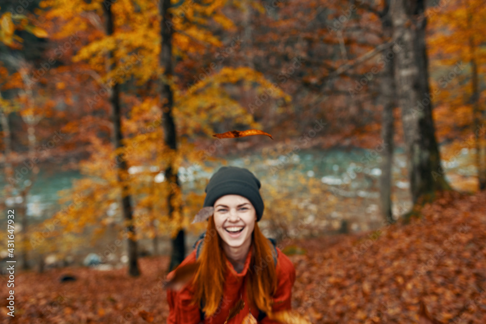 happy woman hiker in the autumn forest near the river gesturing with her hands Copy Space
