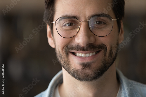 Head shot portrait close up positive bearded man with toothy healthy smile looking at camera, confident businessman in glasses posing for profile picture, happy blogger shooting vlog, recording video