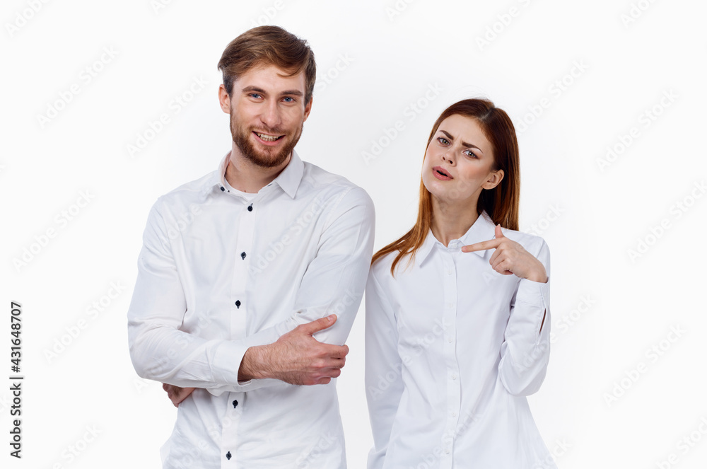 men and women in identical shirts on a light background gesticulate with their hands employees work partners men and women in identical shirts on a light background gesticulate with their hands employees work partners