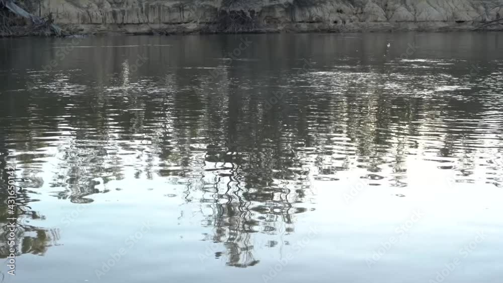 Outdoor nature boat zooms past reflections on river camping