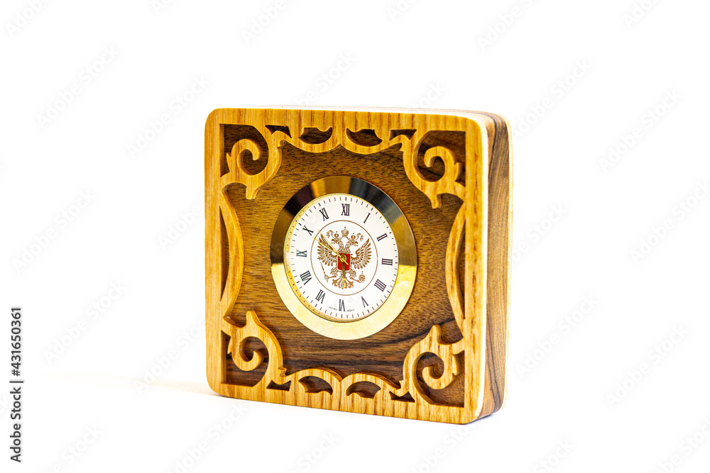 handmade wooden clock with patterns and the emblem of Russia on a white background handmade wooden clock with patterns and the emblem of Russia on a white background
