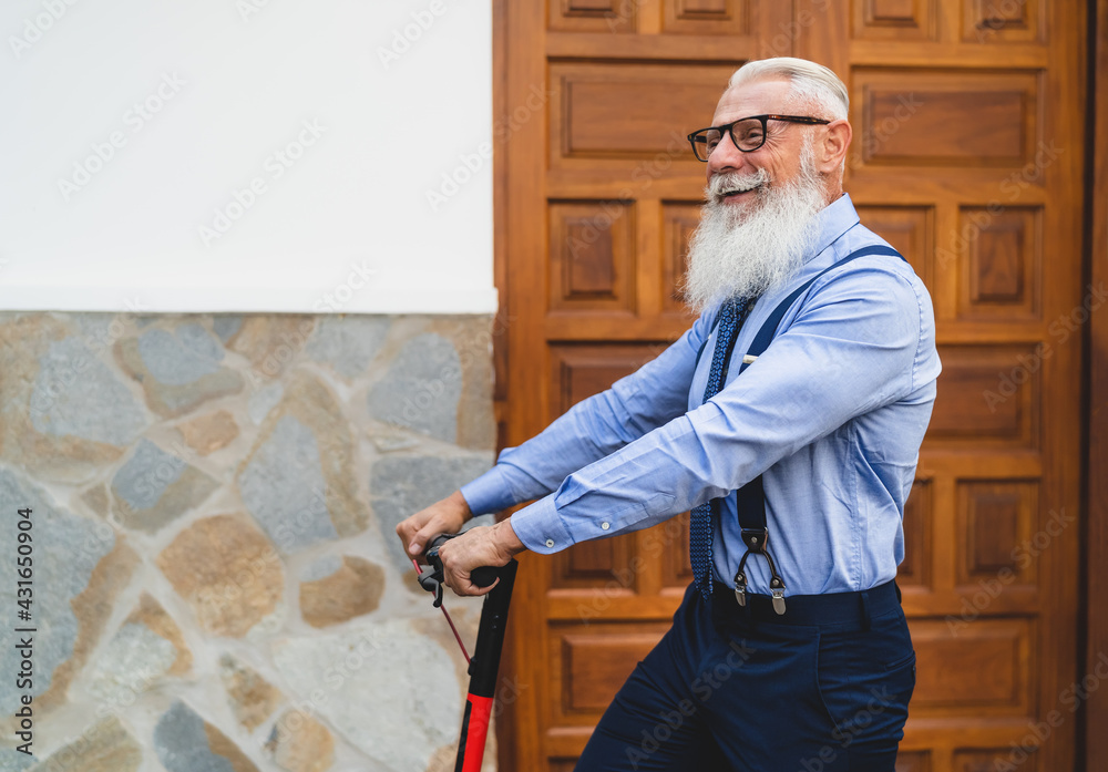 Happy Business senior man going to work with electric scooter - Happy fashion male having fun outdoor