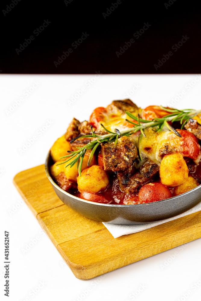 Meat with potatoes and vegetables in a frying pan Meat with potatoes and vegetables in a frying pan