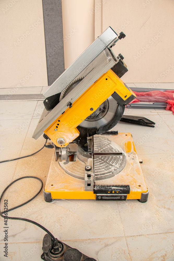 male hands of construction worker sawing and cutting parts of electric