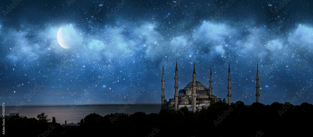 Fototapeta premium Istanbul, Turkey. Sultan Ahmet Camii named Blue Mosque. Front view of crescent shaped moon and mosque in front of night cloudy and starry sky. ramadan, the holy month of muslims. selective focus.