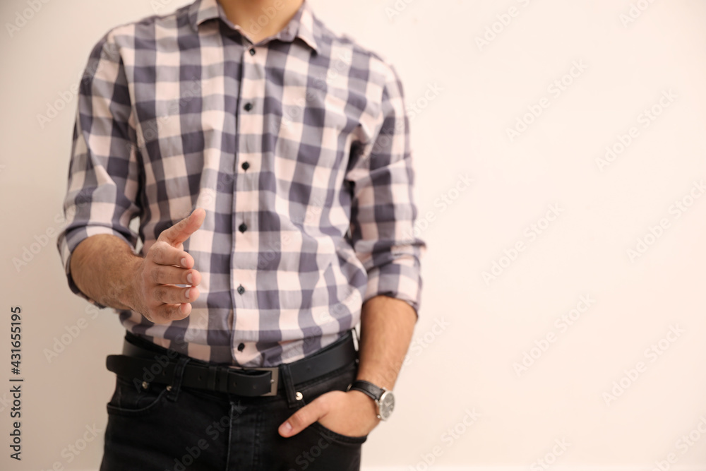 Man offering handshake on beige background, closeup. Space for text Man offering handshake on beige background, closeup. Space for text