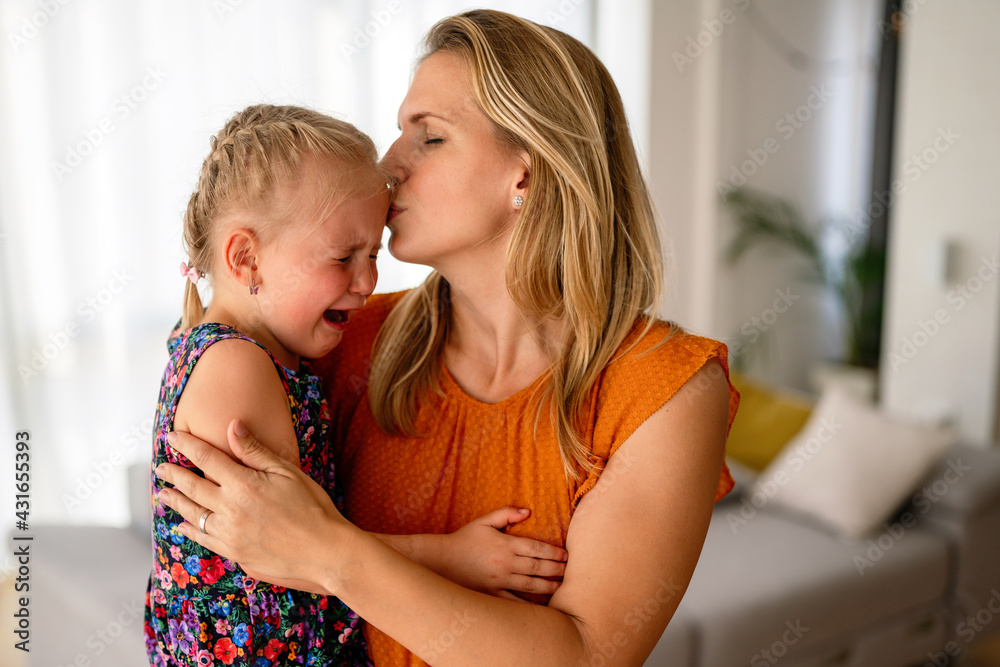 Mother comforting her crying little girl. Parenthood, family, support concept Mother comforting her crying little girl. Parenthood, family, support concept