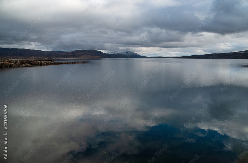 Clouds over the lake, Sylsjøen or Nedalssjøen, Norway, Sweden, with clouds reflected in the water. Clouds over the lake, Sylsjøen or Nedalssjøen, Norway, Sweden, with clouds reflected in the water.