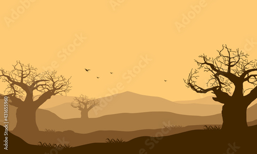 The panorama of the mountains at dusk is really beautiful with the silhouettes of the dry trees around it. Vector illustration