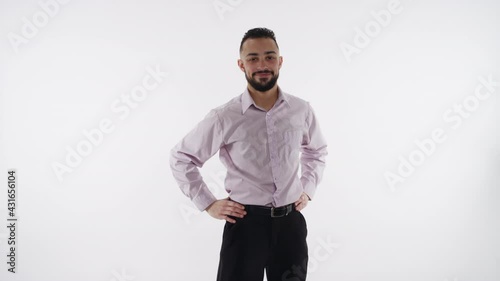 Handsome young worker poses confidently and nods