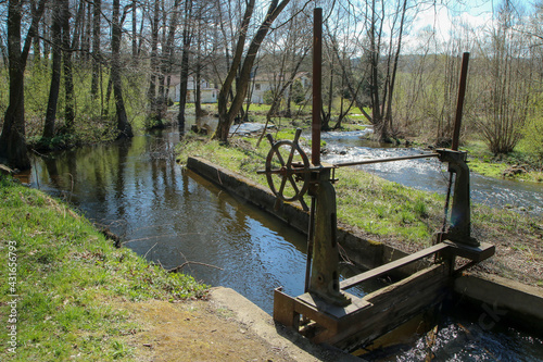 The old defunct floodgate on the small river near Husinec in Czech Republic. Inoperative for a long time.  photo