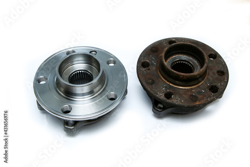 The comparison of the new shiny and old rusty and broken car wheel bearings isolated on a white background. 