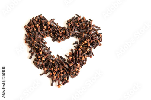 dry cloves on a white background in the shape of a heart. dry seasoning for flavor. medical application.